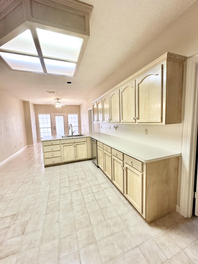 kitchen with dishwasher, light brown cabinets, sink, ceiling fan, and kitchen peninsula