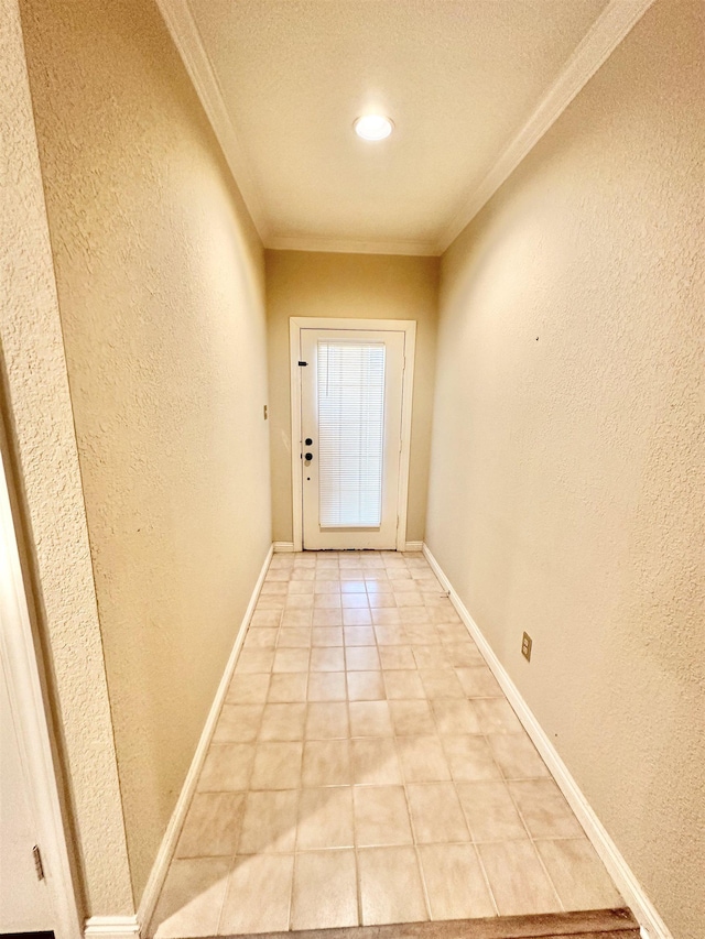 doorway to outside featuring light tile patterned floors, a textured ceiling, and ornamental molding