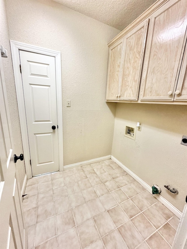 laundry area featuring cabinets, washer hookup, electric dryer hookup, gas dryer hookup, and a textured ceiling