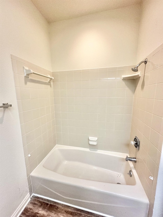 bathroom with shower / tub combination and hardwood / wood-style flooring