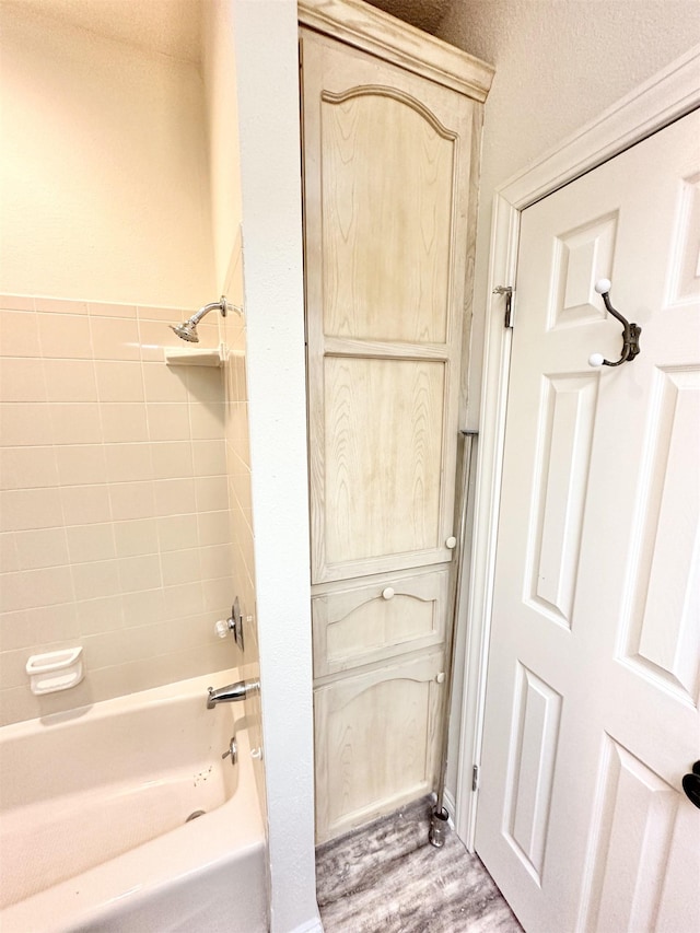 bathroom featuring shower / tub combination and hardwood / wood-style flooring