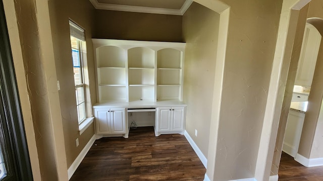 unfurnished office featuring crown molding, baseboards, and dark wood-style flooring