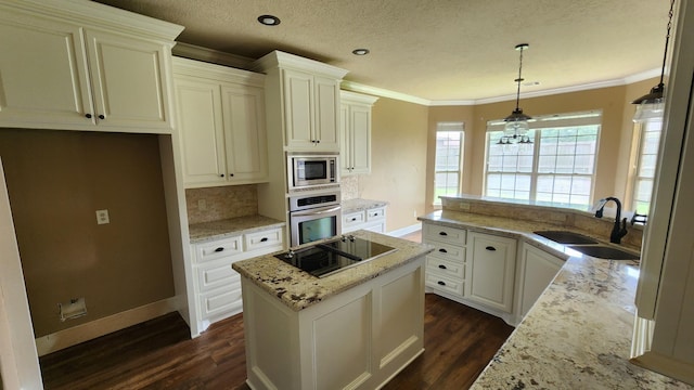 kitchen featuring a sink, stainless steel appliances, dark wood finished floors, ornamental molding, and light stone countertops
