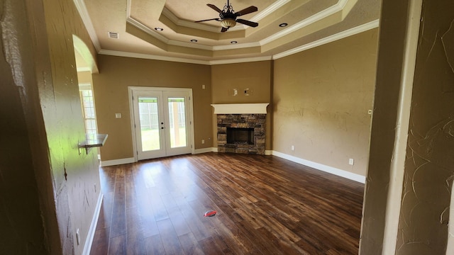 unfurnished living room featuring dark wood-style floors, visible vents, ornamental molding, a fireplace, and ceiling fan
