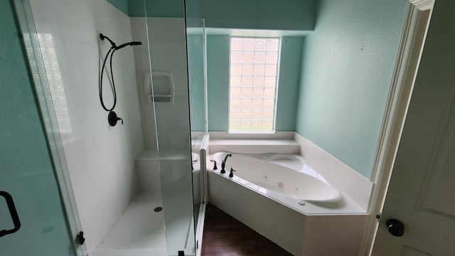 bathroom with a wealth of natural light, a jetted tub, and a stall shower