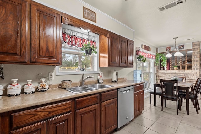 kitchen featuring visible vents, light tile patterned flooring, a sink, dishwasher, and decorative light fixtures