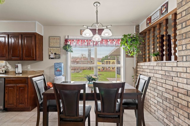 dining space featuring light tile patterned floors and brick wall