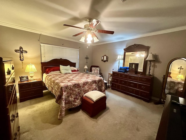 carpeted bedroom featuring ceiling fan and ornamental molding