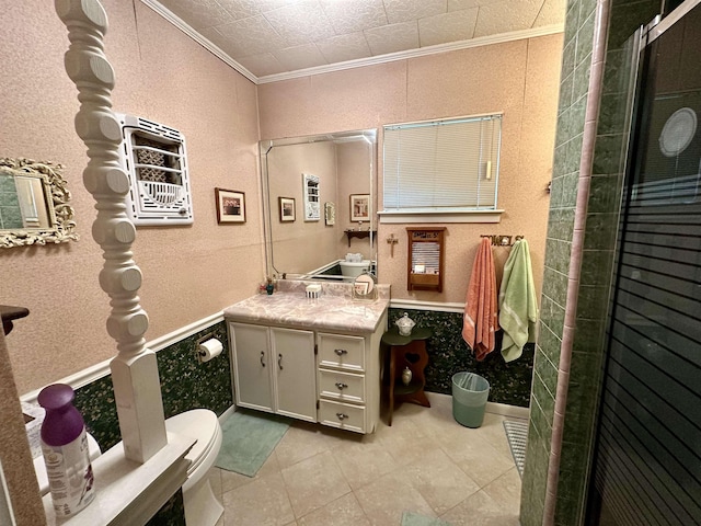 bathroom with tile patterned floors, crown molding, an enclosed shower, toilet, and vanity