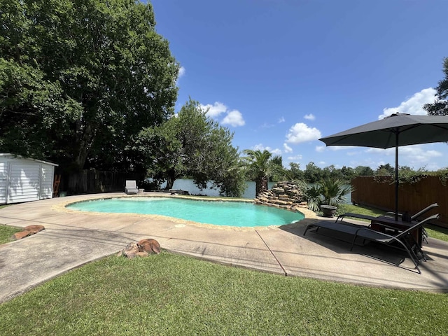 5770 Scenic Dr, Beaumont, TX 77713 - view of swimming pool featuring a fenced backyard, a patio area, and a shed