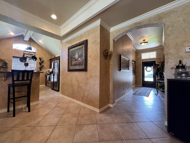 5770 Scenic Dr, Beaumont, TX 77713 - foyer entrance with plenty of natural light, arched walkways, lofted ceiling, crown molding, and light tile patterned flooring