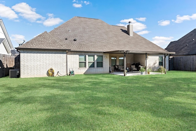 back of property featuring a lawn, central AC, and a patio