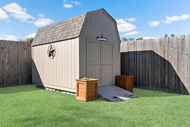 view of outdoor structure featuring a lawn