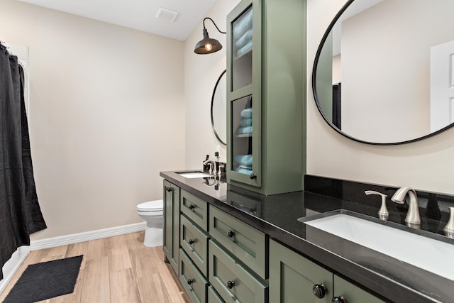 bathroom featuring hardwood / wood-style floors, vanity, and toilet