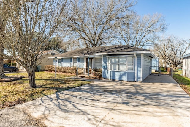 view of front of property with concrete driveway, a gate, and fence