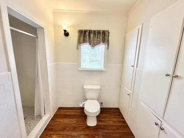 bathroom with walk in shower, ornamental molding, wood-type flooring, tile walls, and toilet