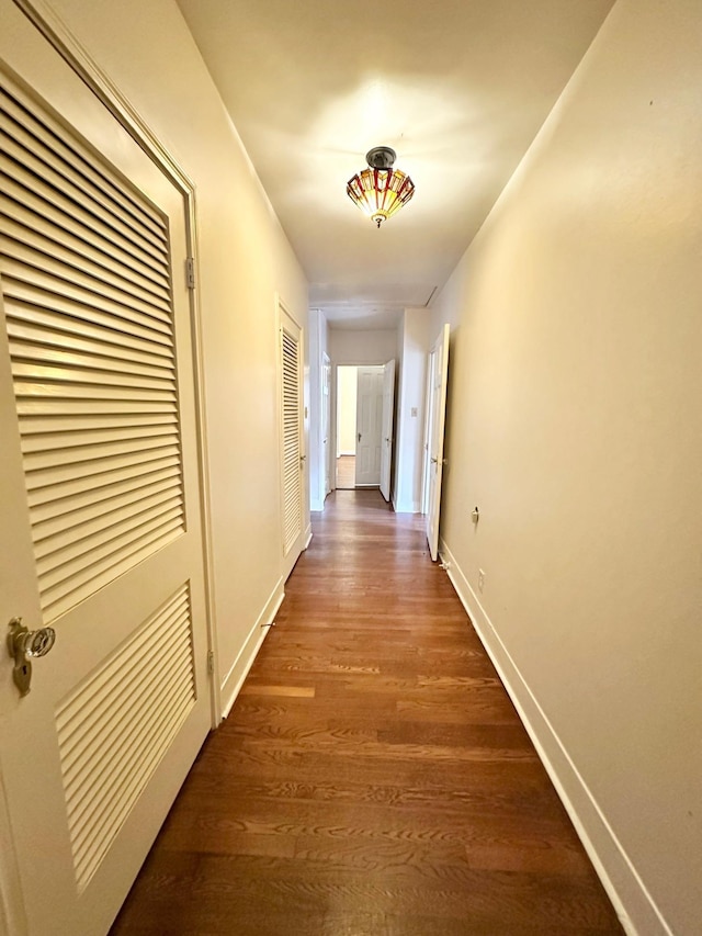 hall with dark hardwood / wood-style flooring