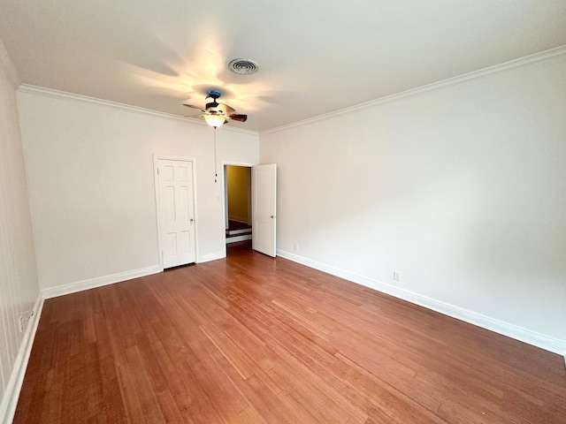 unfurnished room featuring wood-type flooring and crown molding