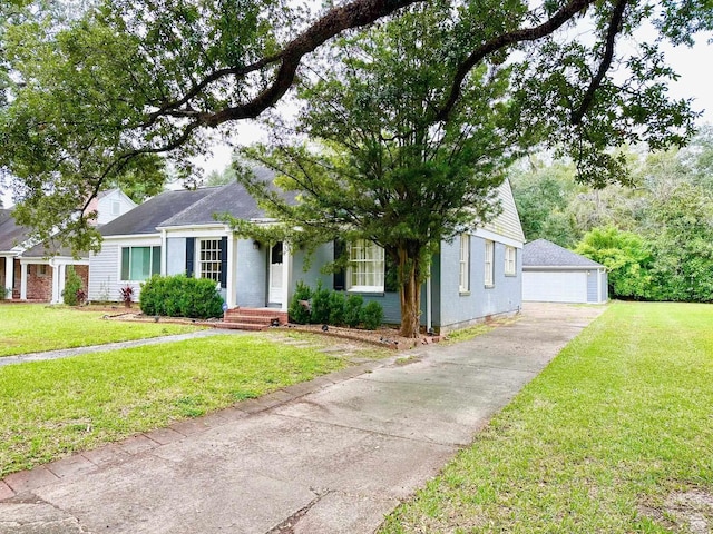 single story home featuring a garage, an outbuilding, and a front yard