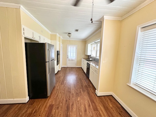 kitchen with sink, dark hardwood / wood-style flooring, white cabinets, black appliances, and ornamental molding