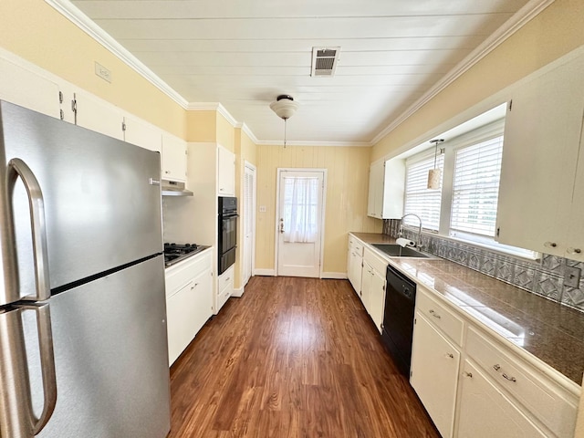 kitchen with dark wood-type flooring, black appliances, sink, ornamental molding, and white cabinetry