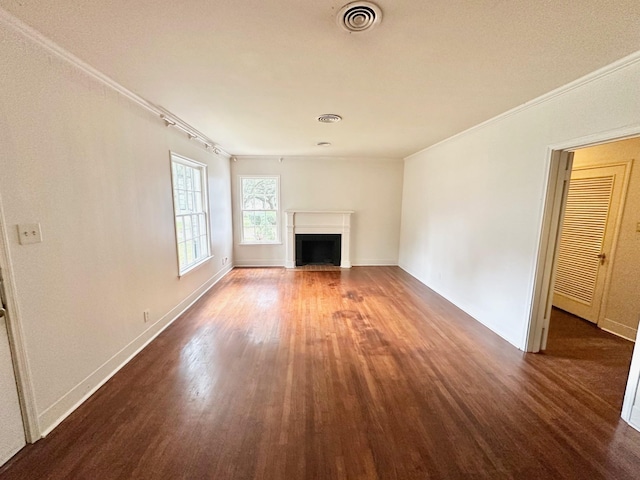 unfurnished living room with dark hardwood / wood-style flooring and crown molding