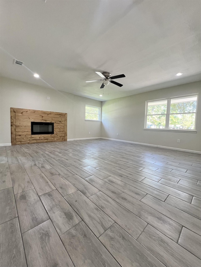 unfurnished living room with ceiling fan