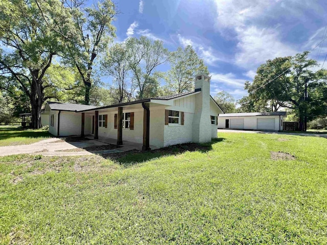 view of property exterior with an outdoor structure, a garage, and a yard