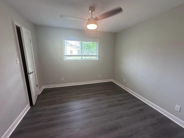 spare room featuring ceiling fan and dark wood-type flooring