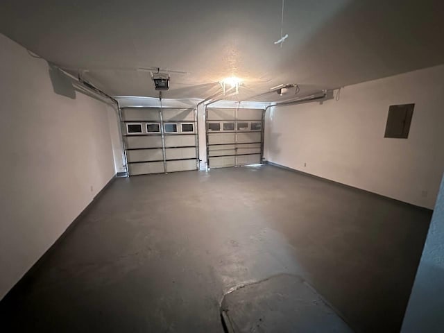 garage featuring electric panel and a garage door opener