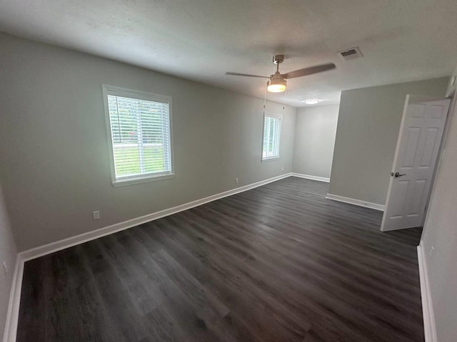 unfurnished room featuring ceiling fan and dark hardwood / wood-style floors