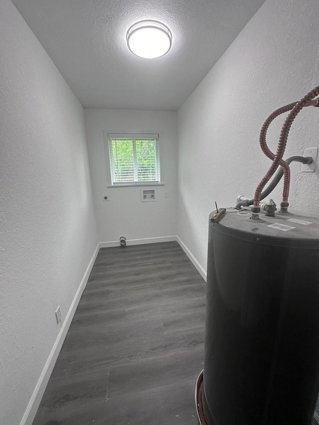 laundry area featuring hookup for an electric dryer, washer hookup, a textured ceiling, dark wood-type flooring, and water heater