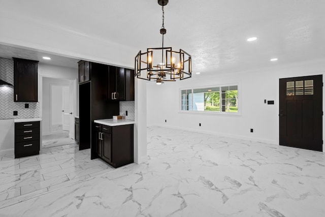 2319 Helena Ave, Nederland, TX 77627 - kitchen with decorative backsplash, open floor plan, a chandelier, light countertops, and recessed lighting