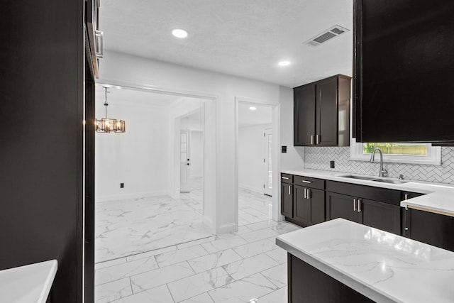 2319 Helena Ave, Nederland, TX 77627 - kitchen with a sink, light marble finish floors, baseboards, tasteful backsplash, and recessed lighting
