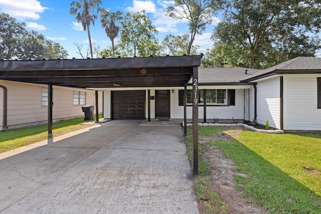 2319 Helena Ave, Nederland, TX 77627 - view of front of home featuring an attached garage, concrete driveway, an attached carport, and a front yard