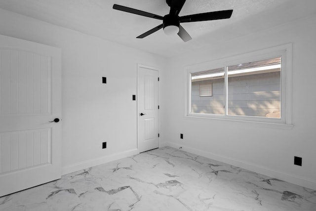 2319 Helena Ave, Nederland, TX 77627 - unfurnished room featuring marble look tiles, a ceiling fan, and baseboards