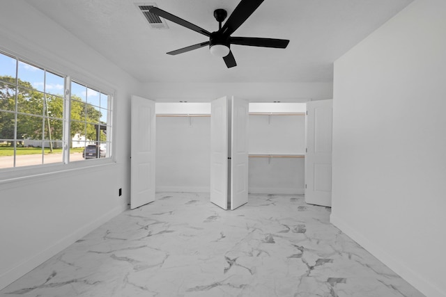 2319 Helena Ave, Nederland, TX 77627 - unfurnished bedroom featuring baseboards, two closets, marble look tile flooring, and ceiling fan