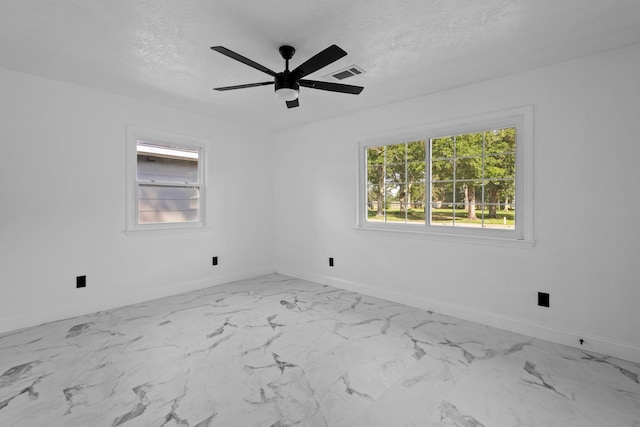 2319 Helena Ave, Nederland, TX 77627 - spare room featuring baseboards, light marble finish flooring, a ceiling fan, and a textured ceiling