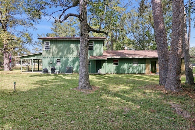 back of house featuring cooling unit and a lawn