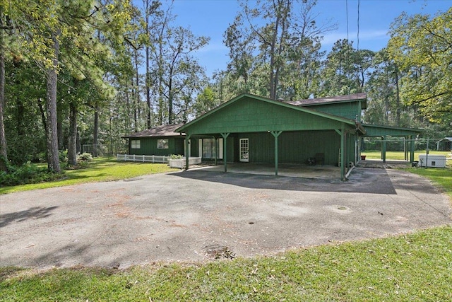 exterior space featuring a front yard and a carport