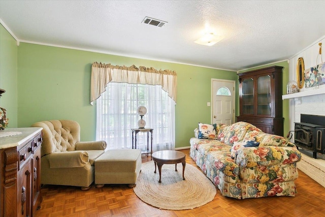 living room featuring a textured ceiling, a wood stove, parquet floors, and crown molding