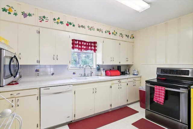 kitchen featuring white cabinets, backsplash, stainless steel appliances, and sink