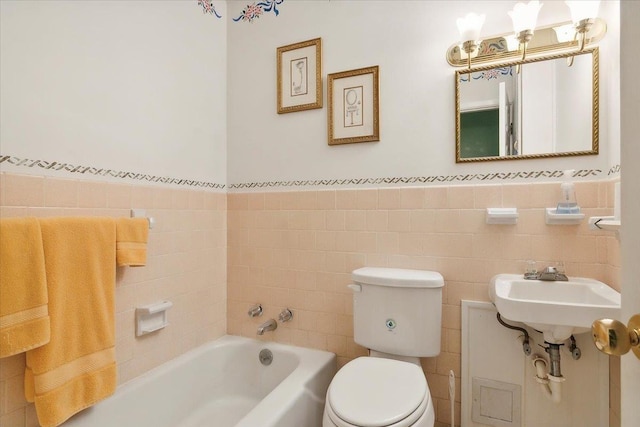 bathroom with toilet, tile walls, a tub, and sink