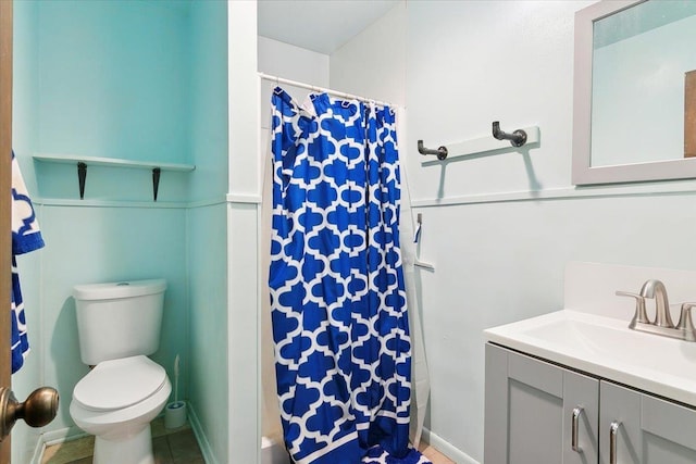 bathroom with vanity, toilet, and walk in shower