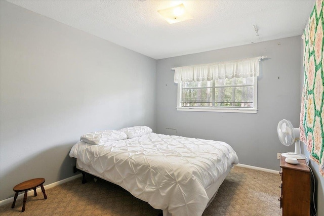 bedroom with carpet floors and a textured ceiling