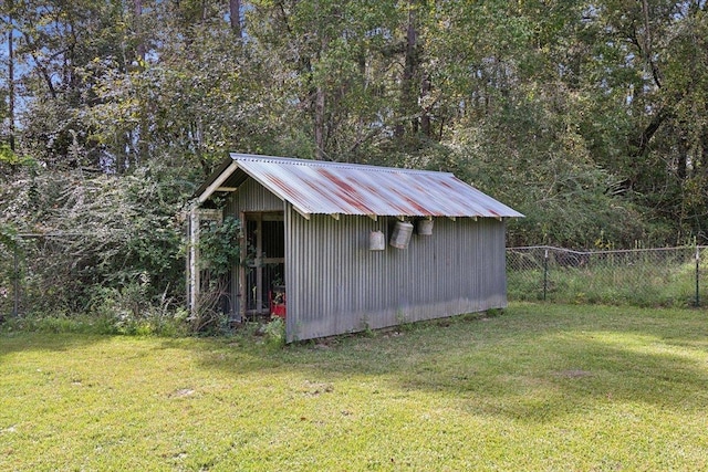 view of outbuilding with a yard