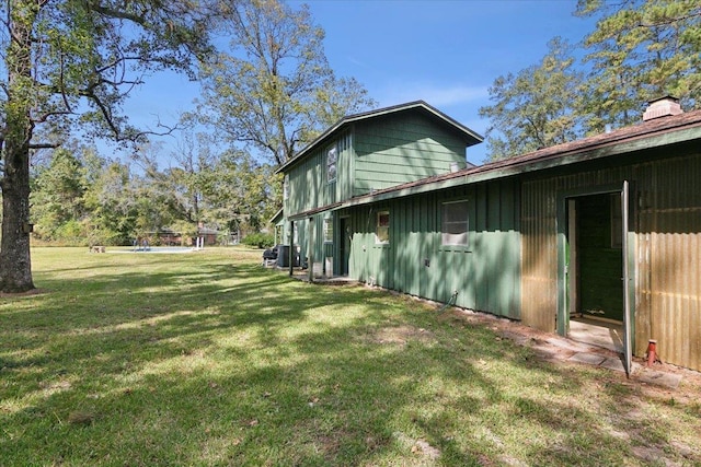 view of home's exterior featuring a lawn and central AC