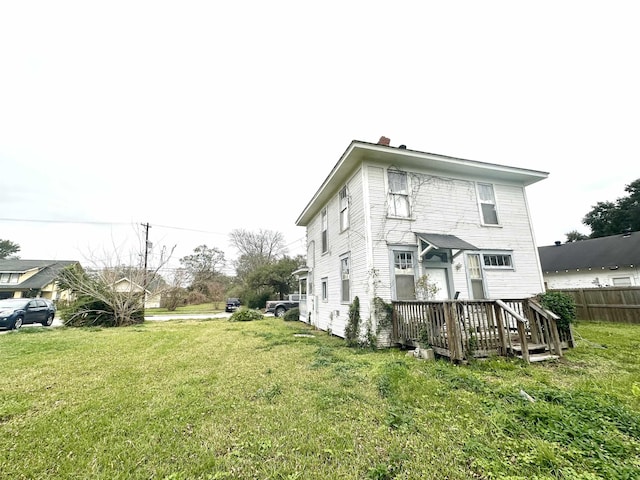 rear view of property featuring a yard