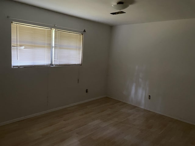 unfurnished room with light hardwood / wood-style flooring