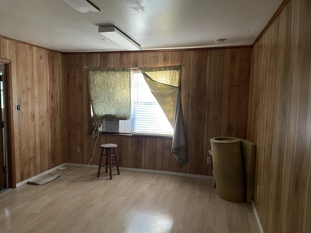 empty room featuring light hardwood / wood-style floors and wood walls